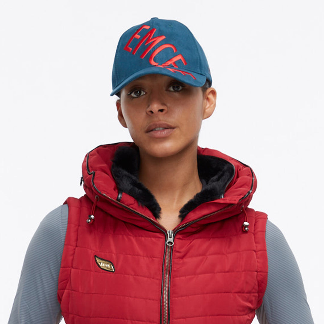 Close up of a model wearing an Emcee hat and Dana Vest