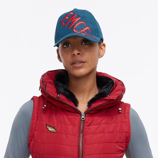 Close up of a model wearing an Emcee hat and Dana Vest