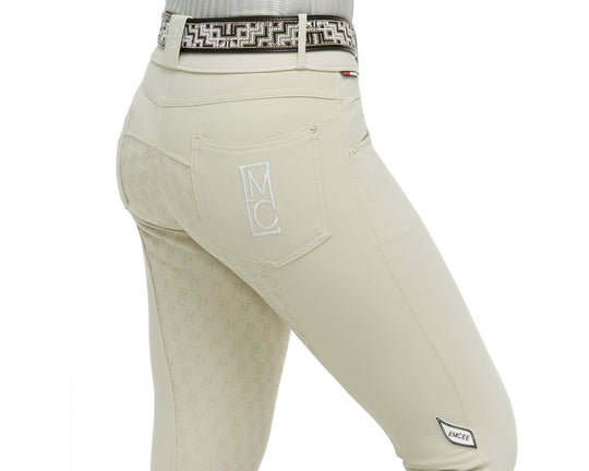 Beige equestrian pants with a patterned belt on a white background