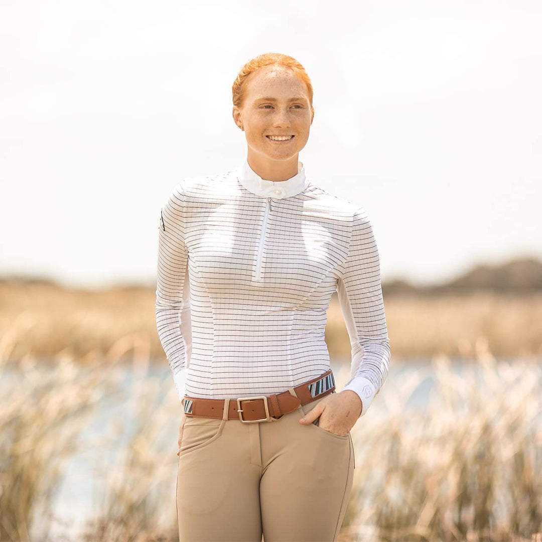 Equestrian model facing the camera wearing Emcee Apparel's Cantika in white